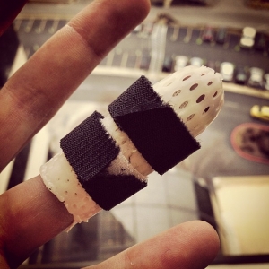 Well...official diagnosis is that my finger is broken in two places, but will not require surgery. The hand specialist said he was shocked I could still move it. Got this nifty little custom splint to keep all the pieces lined up.