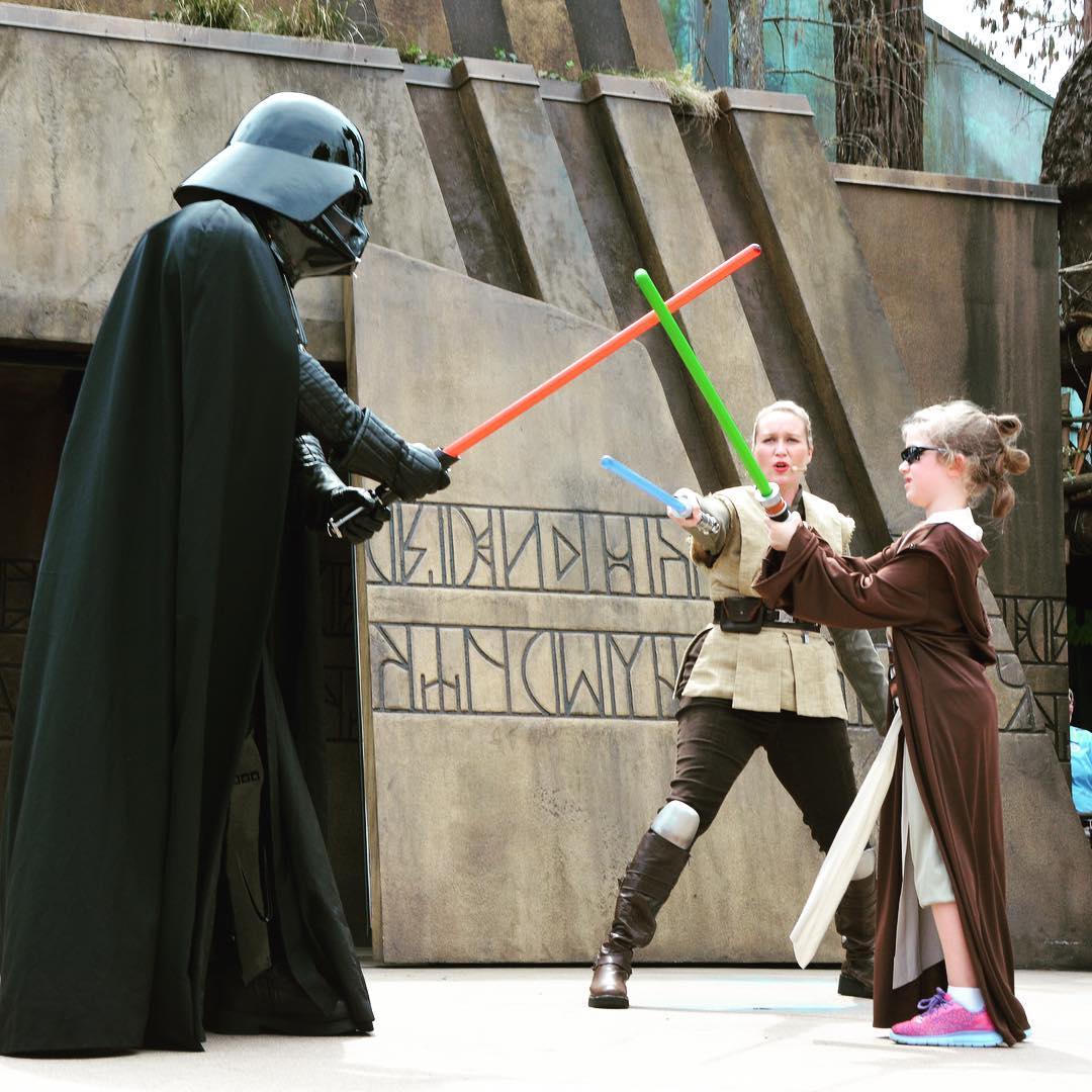 Sara "Baby Rey" Agee throwing down with Darth Vader during Jedi Training at #Disney Hollywood Studios. #travel #family #StarWars