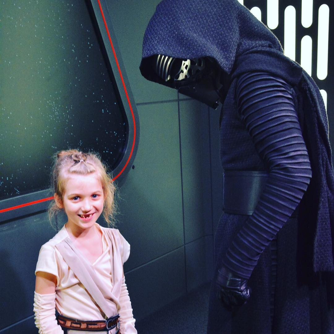 Sara "Baby Rey" Agee simply laughs as Kylo Ren tries to stare her down. #Disney #StarWars #family #travel